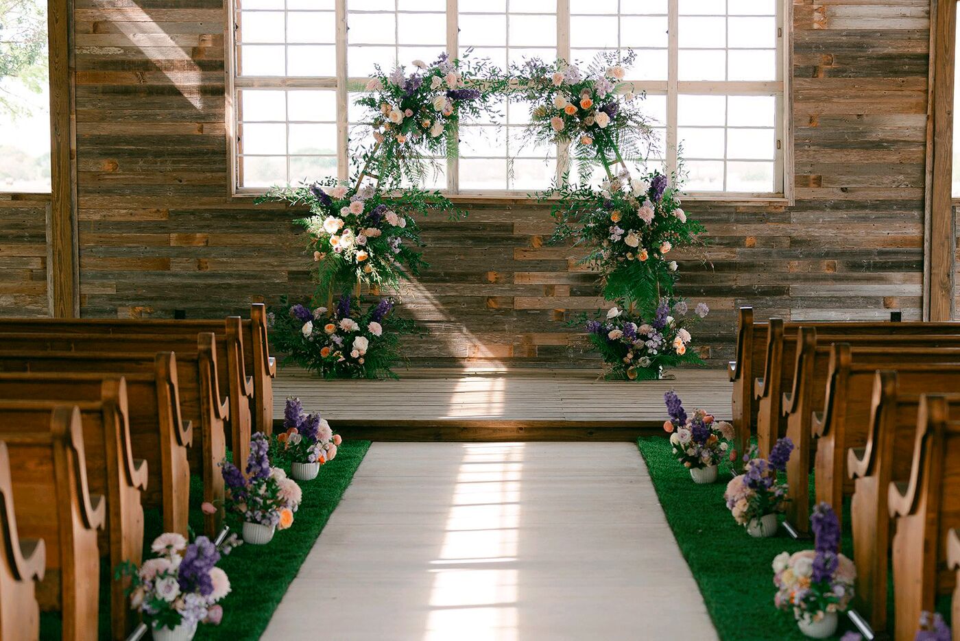 Floral arch at the front of the chapel aisle