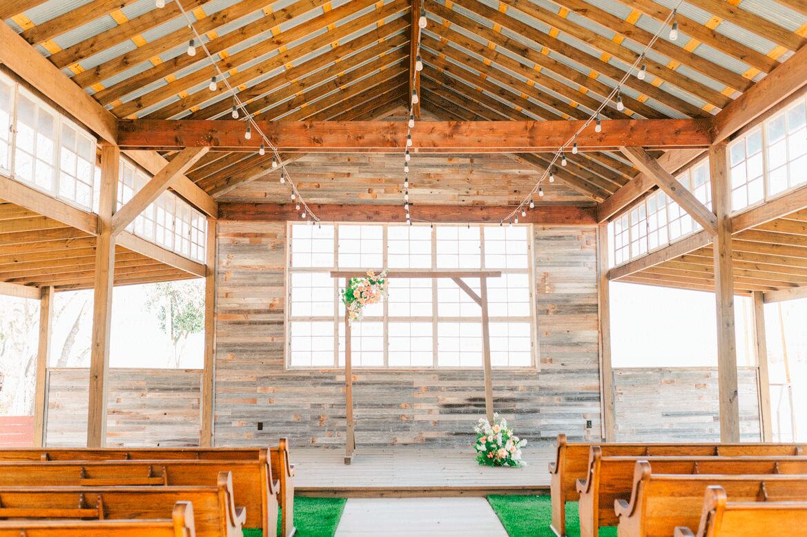 Inside the open-air chapel looking toward the reclaimed wood wall and window