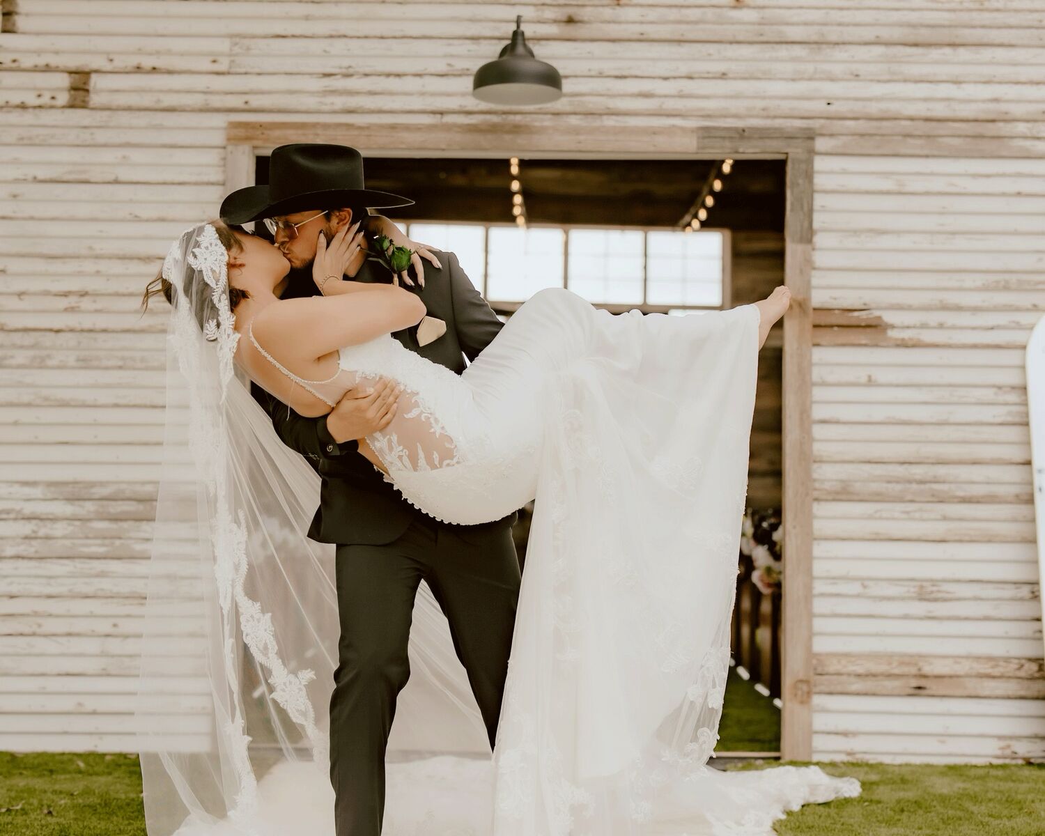 Groom carrying the bride in the chapel doorway